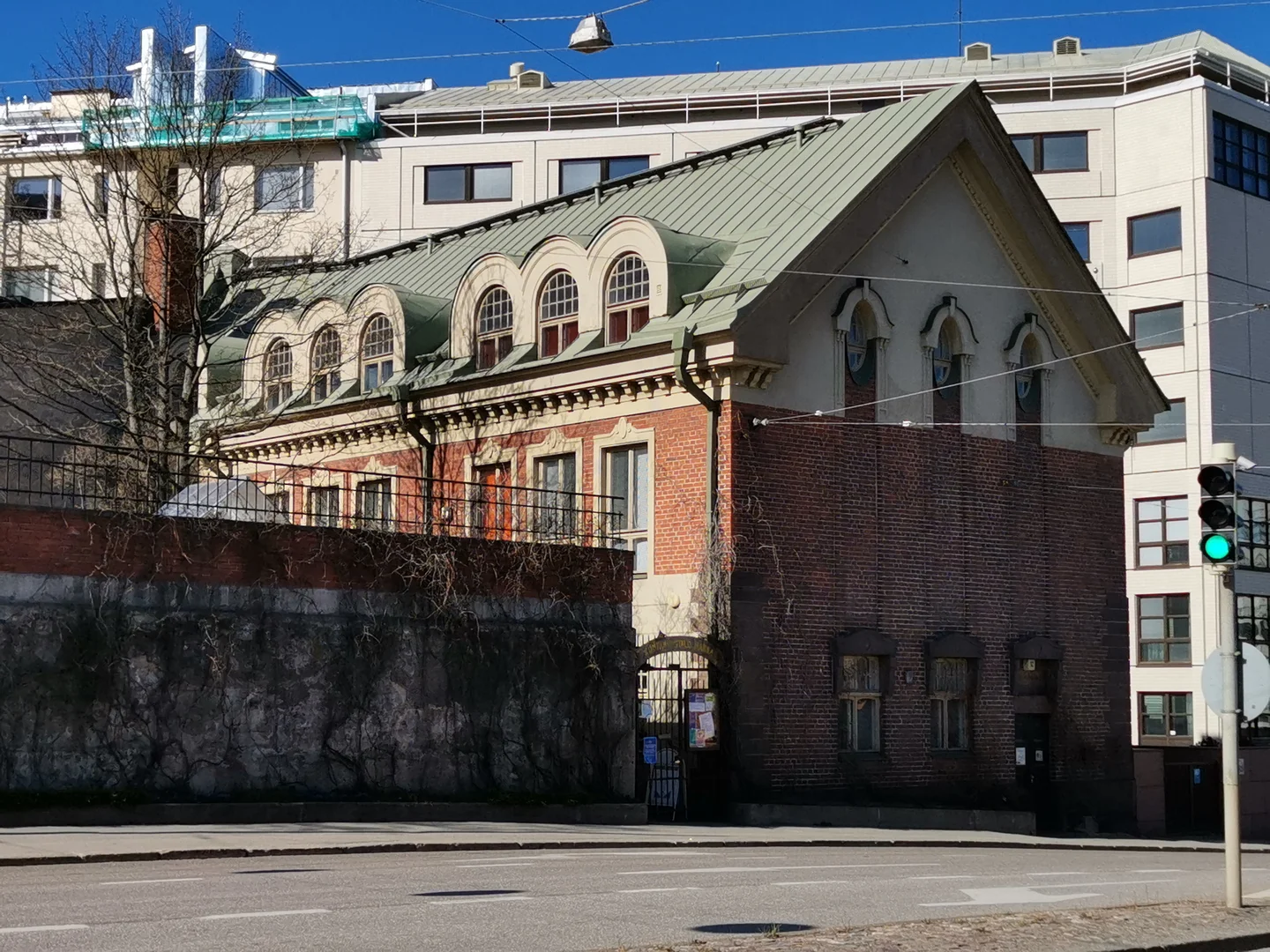 The red-brick building at Sturenkatu 12 with arched windows and its street entrance